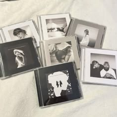 six black and white photos are arranged on a bed