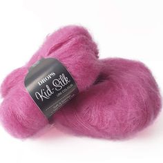 two skeins of pink wool on a white background