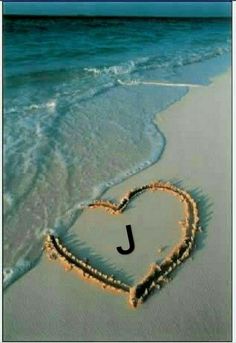 a heart drawn in the sand at the beach