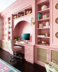 a home office with pink walls and shelves, wicker baskets on the desks