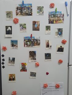 a refrigerator covered in pictures and magnets with flowers on the front, and paper roses attached to the door