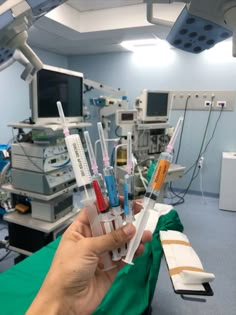 a person holding up some medical equipment in a room