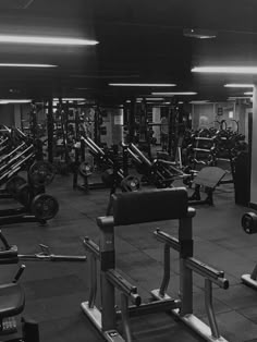 the gym is full of weight machines and dumbbells in black and white photo