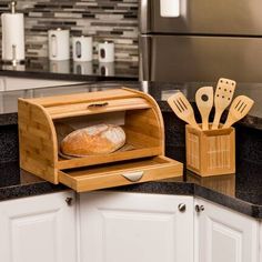 a loaf of bread is in an oven with utensils and spatulas