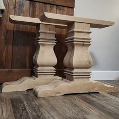 a wooden table sitting on top of a hard wood floor next to a lamp shade