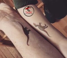 two people with tattoos on their legs and one has a lizard tattoo on the leg