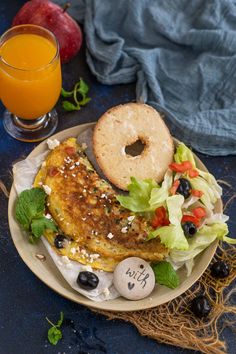 the best greek omelette is served on a plate with bread, lettuce and olives