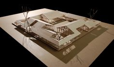 an architectural model of a building with trees in the foreground and shadows on the ground