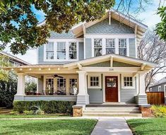 a gray house with white trim and two story