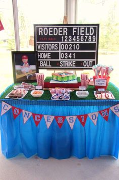 a table topped with lots of food next to a sign