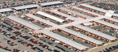 an overhead view of a parking lot with many cars parked in it and several buildings