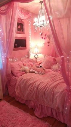 a bedroom with pink walls and lights on the ceiling is decorated in shades of pink