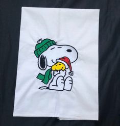 a white towel with a cartoon character on it's side and a green hat