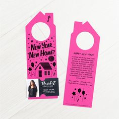 a pink door hanger with an image of a house on it and the words happy new home