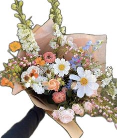 a person holding a bouquet of flowers in their hand