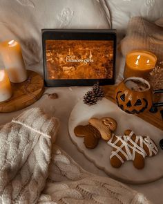 some cookies and candles are on a tray next to a sign that says ginger god