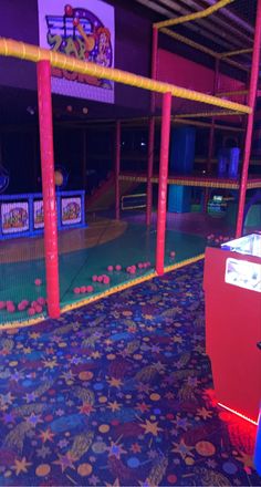 an arcade machine in the middle of a colorful carpeted area with neon lights on it