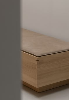 a wooden box sitting on top of a white floor