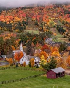 a small town surrounded by trees in the fall