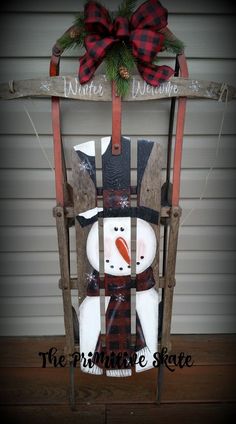 a wooden sled with a snowman on it