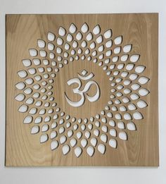 a wooden plaque with an omastha symbol on it's center and white petals in the middle