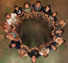 a group of people standing in the shape of a circle