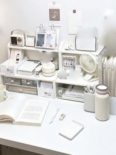 a white desk topped with lots of different items