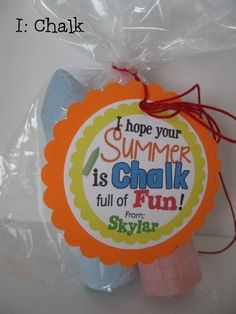 a plastic bag filled with candy sticks and a tag that says, i hope your summer is chalk full of fun from skyler