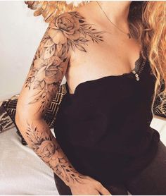 a woman with tattoos on her arm and shoulder