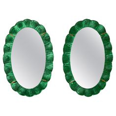 two round mirrors with green tinsel on them, one in the shape of a flower