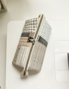 an open zippered purse sitting on top of a white table