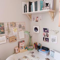 a white desk topped with lots of books and papers