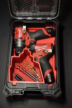 an open tool box filled with tools on top of a table