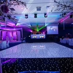 the dance floor is lit up with purple lights