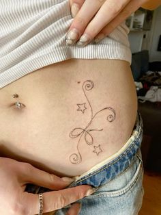 a pregnant woman with an intricate tattoo on her belly is shown in this undrecognized photo