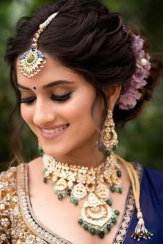 a woman wearing a necklace and earrings