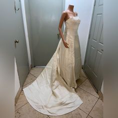 a mannequin dressed in a wedding dress standing next to a door