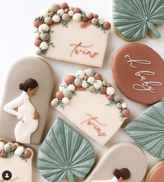 decorated cookies are arranged on a white surface