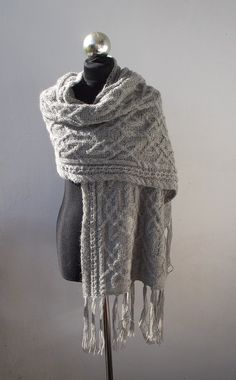 a white knitted shawl on a mannequin