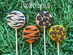 three cake pops sitting in the grass on top of each other with chocolate toppings