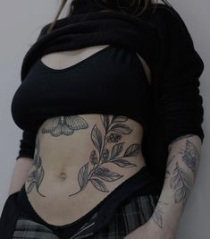 a pregnant woman with tattoos on her stomach