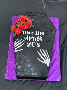 there is a cake that has been decorated to look like a rock with roses on it