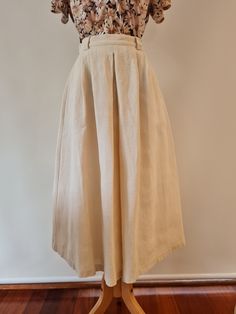 Sportscraft Made in Australia Beautiful Sportscraft 1990's Cream/Natural 100% Raw Silk pleated skirt with a fixed waistband.  This beautiful midi length full skirt has a narrow waistband with wide belt loops, and a central inverted pleat at front and back with two deep pleats either side.  With angled slant pockets, this beauty is fully lined.  Made to wear with tan accessories this is a gorgeous skirt perfect for a wedding or for work.  The natural slubs of this raw silk give the skirt a beauti Ceremonial Cream Raw Silk Sets, Cream Full Cotton Skirt, Ivory Silk Midi Skirt, Vintage Cream Lined Skirt, Vintage White Gathered Skirt, Silk Pleated Skirt, Tan Accessories, Mid Length Skirt, Mid Length Skirts