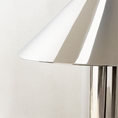 a lamp that is on top of a white wall and it's light turned on