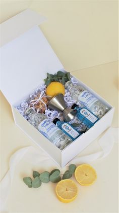 an open white box with lemons and body care products