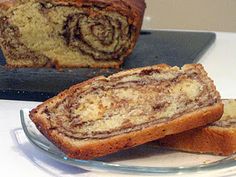 a loaf of cinnamon swirl bread sitting on top of a plate next to another loaf