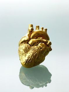 a gold heart shaped object sitting on top of a table