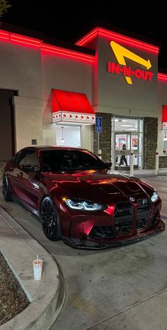 a red sports car parked in front of a fast food restaurant