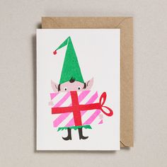 a greeting card with an image of a gnome holding a present on it's chest