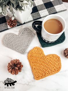 crocheted heart coasters with coffee and pine cones